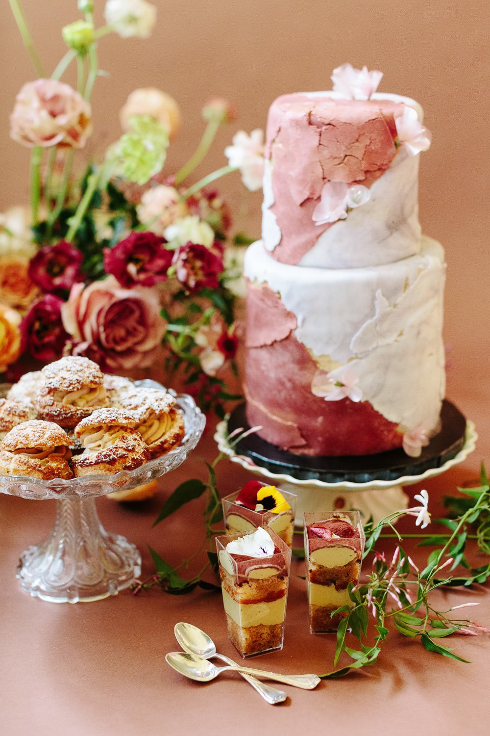 textured two tier cake with desserts
