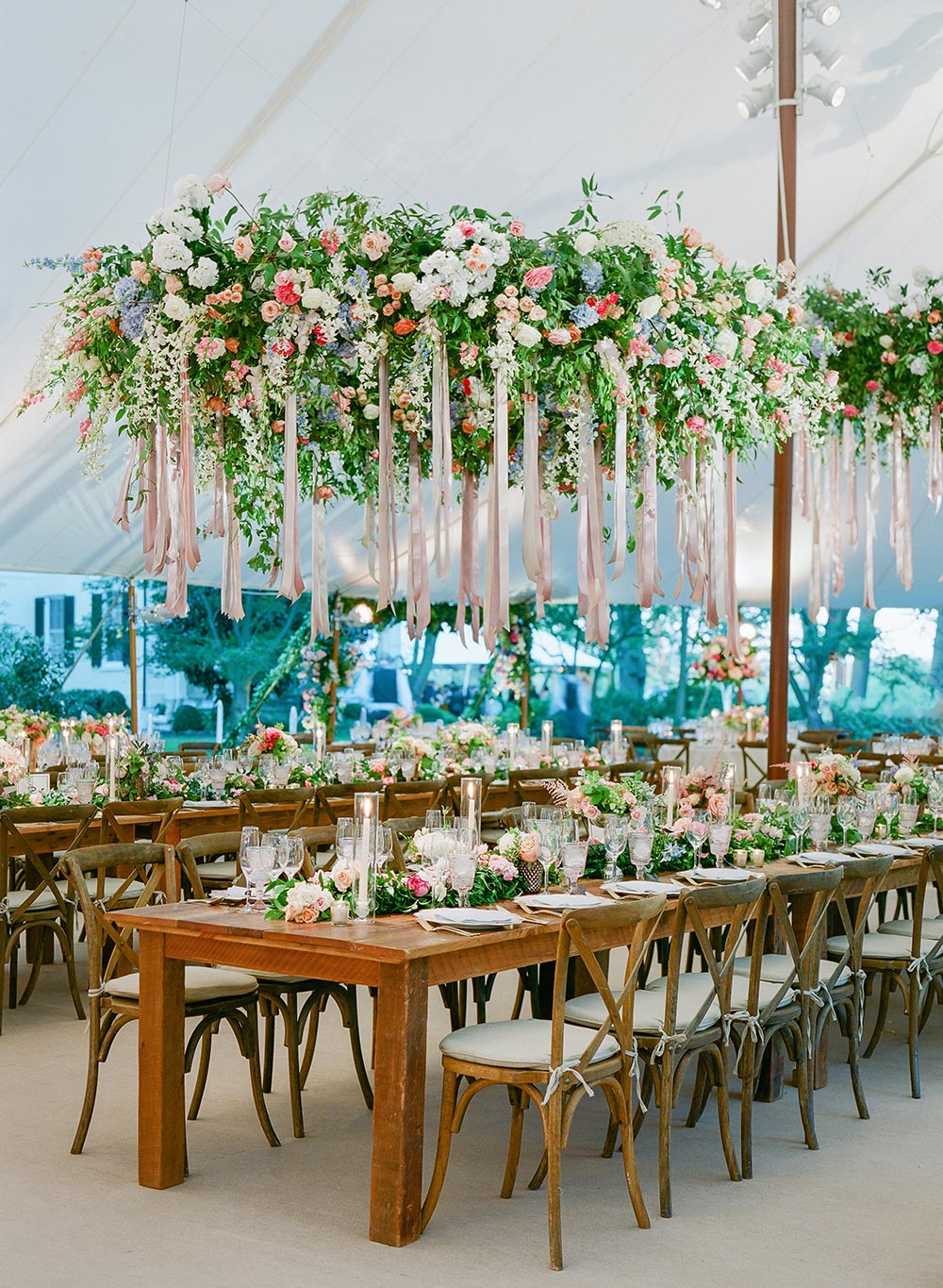 tented wedding reception with flower and ribbon chandeliers