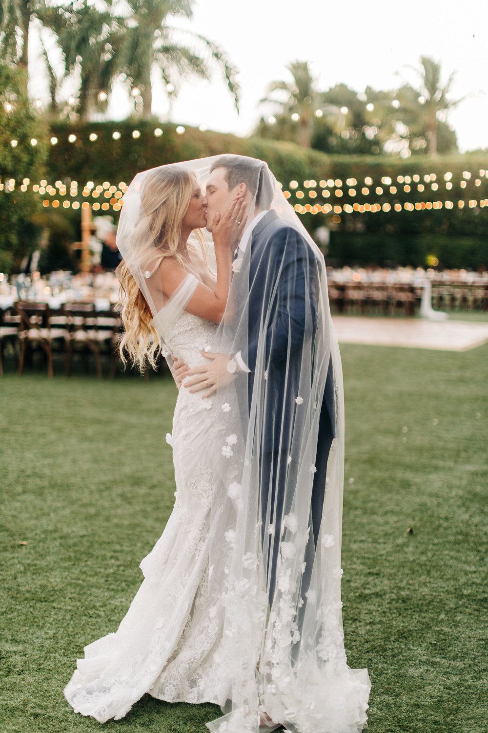 bride and groom kiss under the bride's veil
