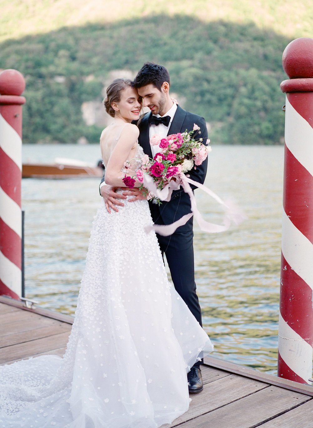 bride and groom portrait on the dock on Lake Como
