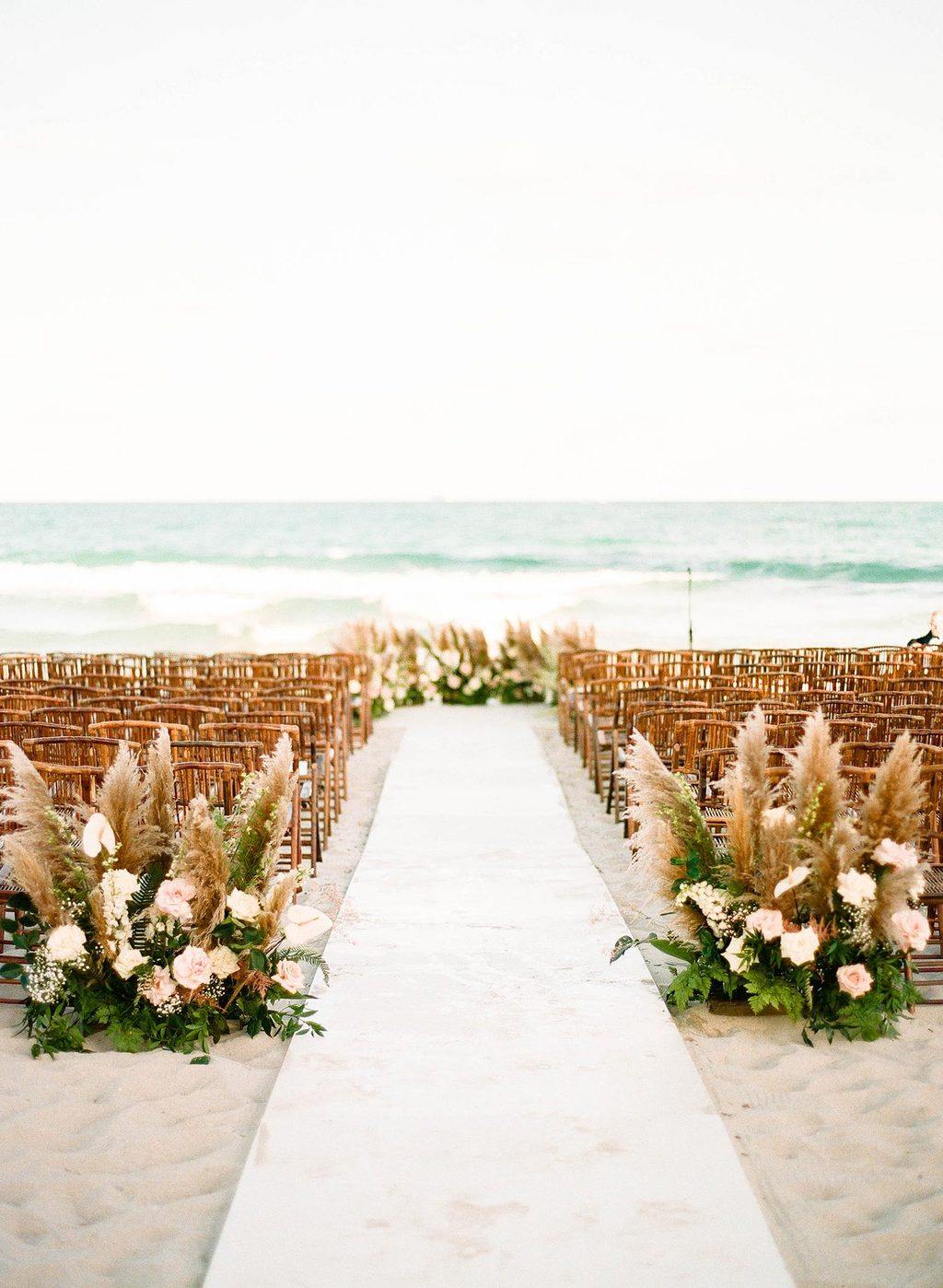 pampas grass wedding ceremony with bamboo chairs